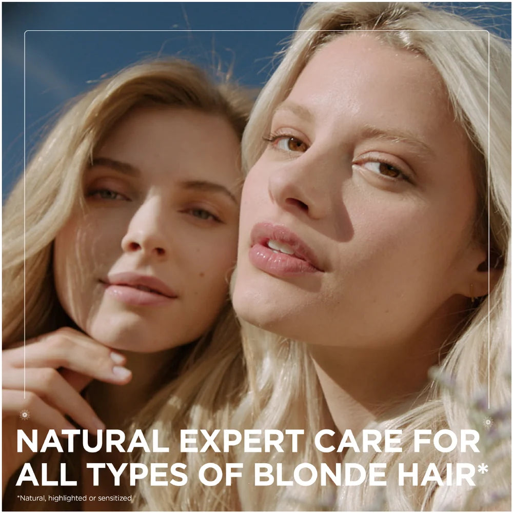 Garnier Ultra Doux illuminating shampoo with chamomile and flower honey for bright, healthy hair, shown in a sleek bottle.