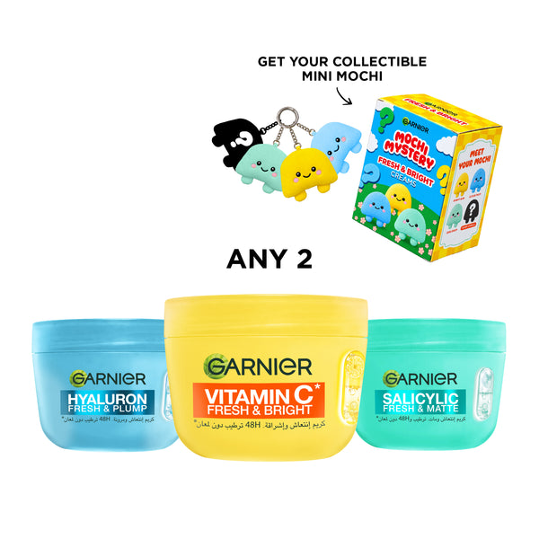 Two Garnier Fresh & Bright creams with a gift box, featuring colorful packaging and skincare products in a clean, bright setting.