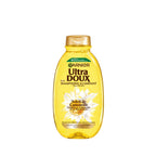 Garnier Ultra Doux camomile and flower honey illuminating shampoo bottle with a clean, natural hair care design.