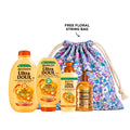 Garnier Honey Treasures shampoo, conditioner, leave-in, and serum set with honey-infused hair care products in bottles and tubes.