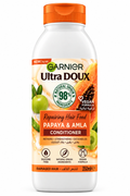 Garnier Ultra Doux Hair Food Papaya & Amla Shampoo bottle with natural ingredients visible, casual hair care product.