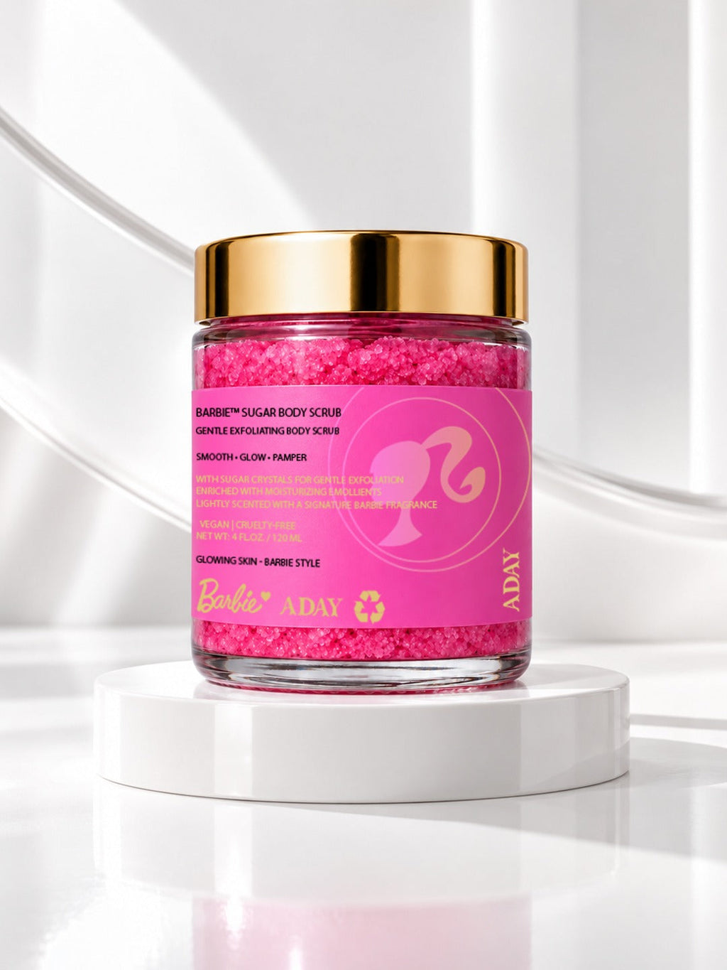 ADAY x Barbie Sugar Body Scrub, a glass jar of hot-pink scrub with a gold lid on a white pedestal