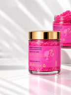 Two jars of ADAY x Barbie Sugar Body Scrub, one heaped with pink sugar crystals