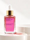 ADAY Crystal Rush Shimmer Body Serum, a 50 ml glass dropper bottle of pink shimmer on a white pedestal