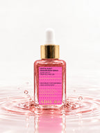 ADAY Crystal Rush Shimmer Body Serum standing in a splash of pink water