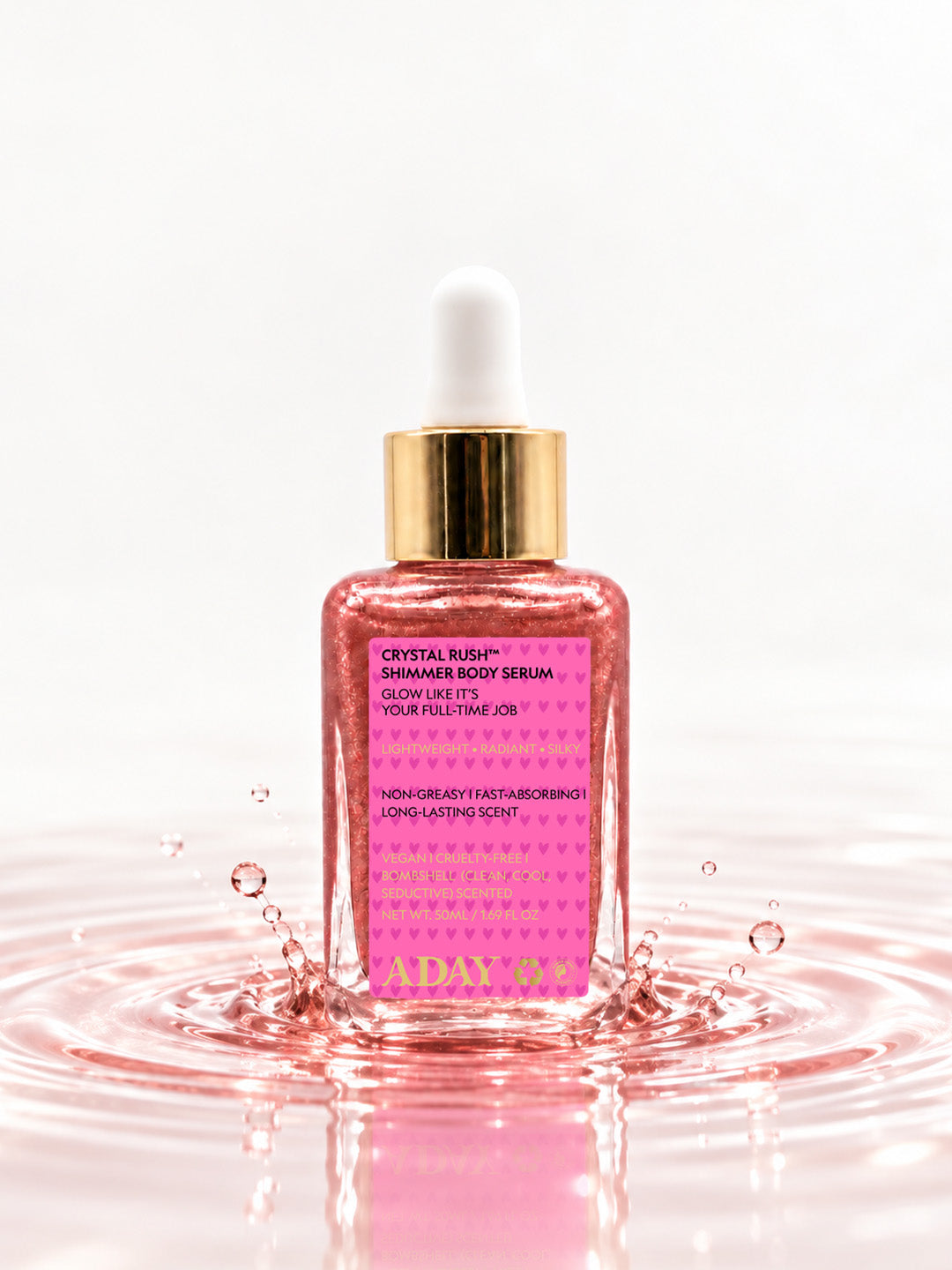 ADAY Crystal Rush Shimmer Body Serum standing in a splash of pink water