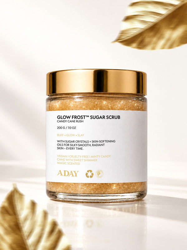 A closed jar of ADAY Glow Frost Sugar Scrub with gilded palm leaves on cream silk