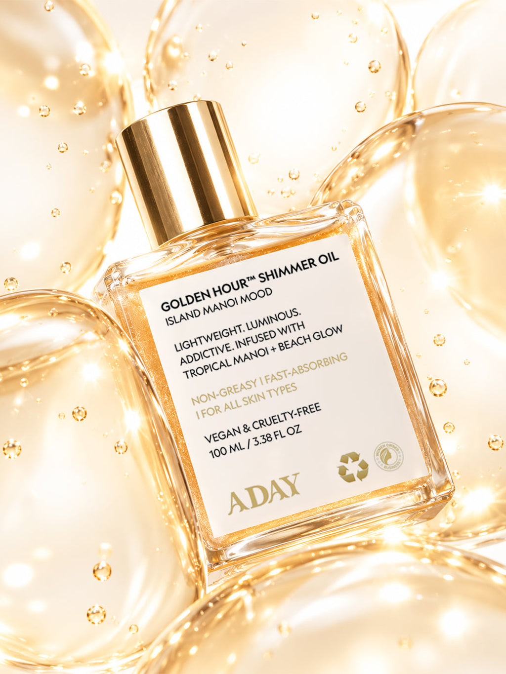 ADAY Golden Hour Shimmer Oil surrounded by golden bubbles