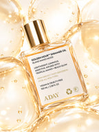 ADAY Golden Hour Shimmer Oil surrounded by golden bubbles