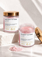 Two jars of ADAY Rosy Crush Salt Scrub, one open beside a scoop of pink scrub