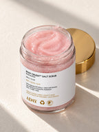 An open jar of ADAY Rosy Crush Salt Scrub showing the pink sugar crystals