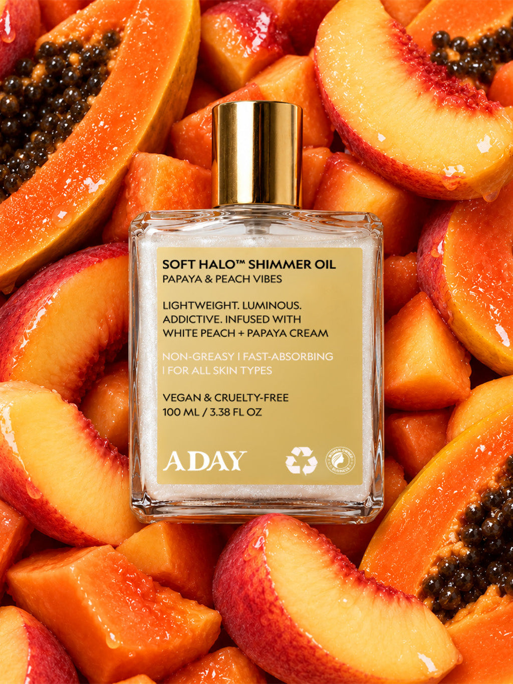 ADAY Soft Halo Shimmer Oil among fresh papaya and peach slices