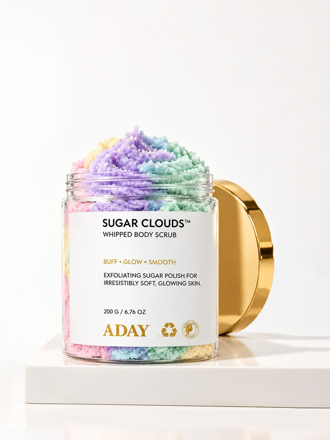 ADAY Sugar Clouds Whipped Body Scrub open with the gold lid resting behind it