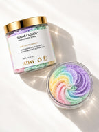 ADAY Sugar Clouds Whipped Body Scrub beside a dish of the rainbow-swirled sugar polish