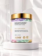 ADAY Sugar Clouds Whipped Body Scrub, a 200 g jar with a gold lid, on a white pedestal