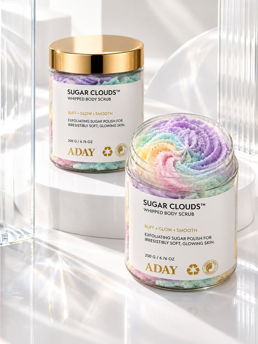 Two jars of ADAY Sugar Clouds Whipped Body Scrub, one open to show the swirl