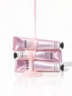 Three tubes of ADAY Pink Shimmer Toothpaste stacked with paste pouring over them