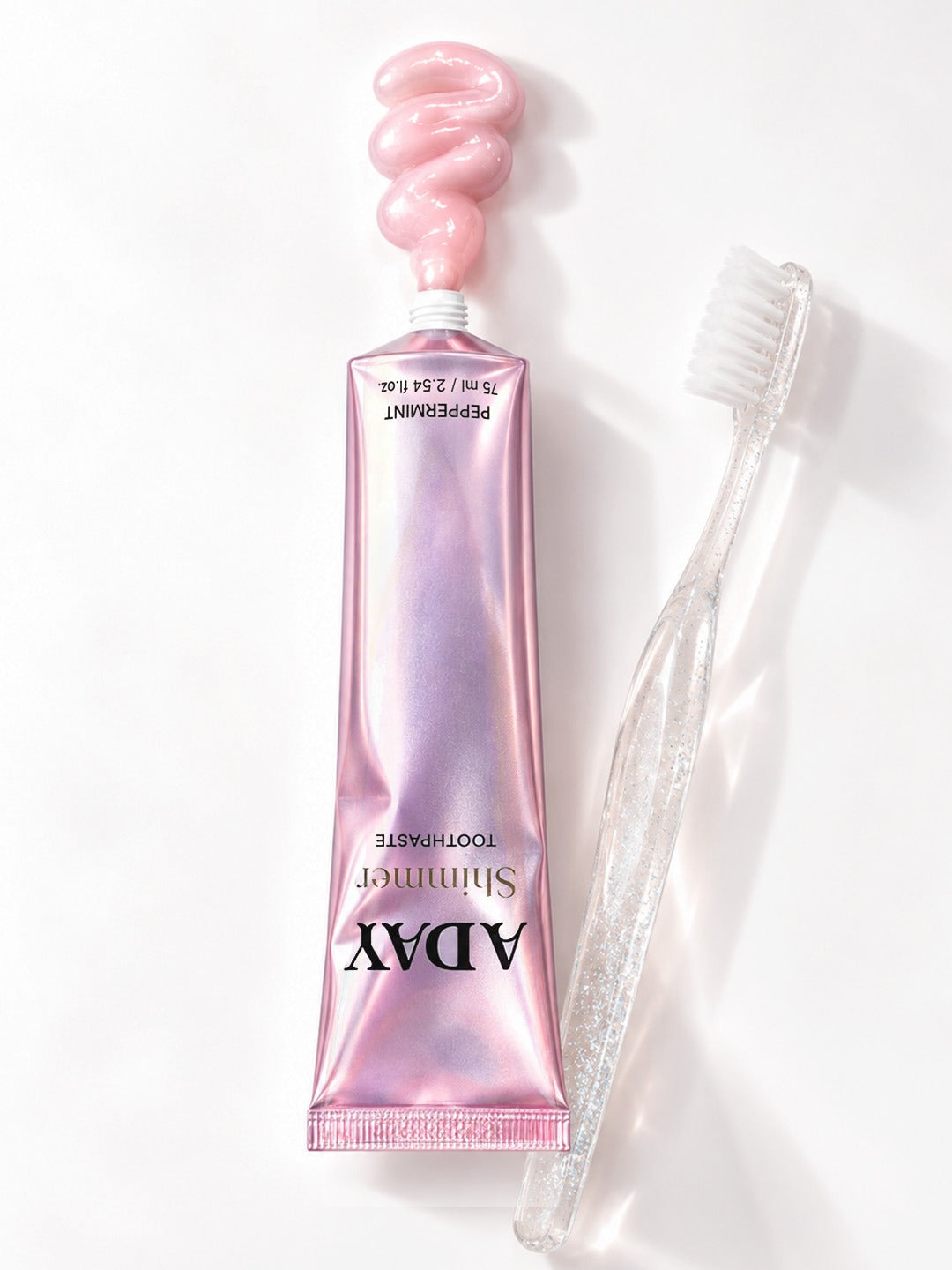 ADAY Pink Shimmer Toothpaste squeezed onto a toothbrush