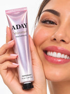 A model holding the ADAY Pink Shimmer Toothpaste beside her smile