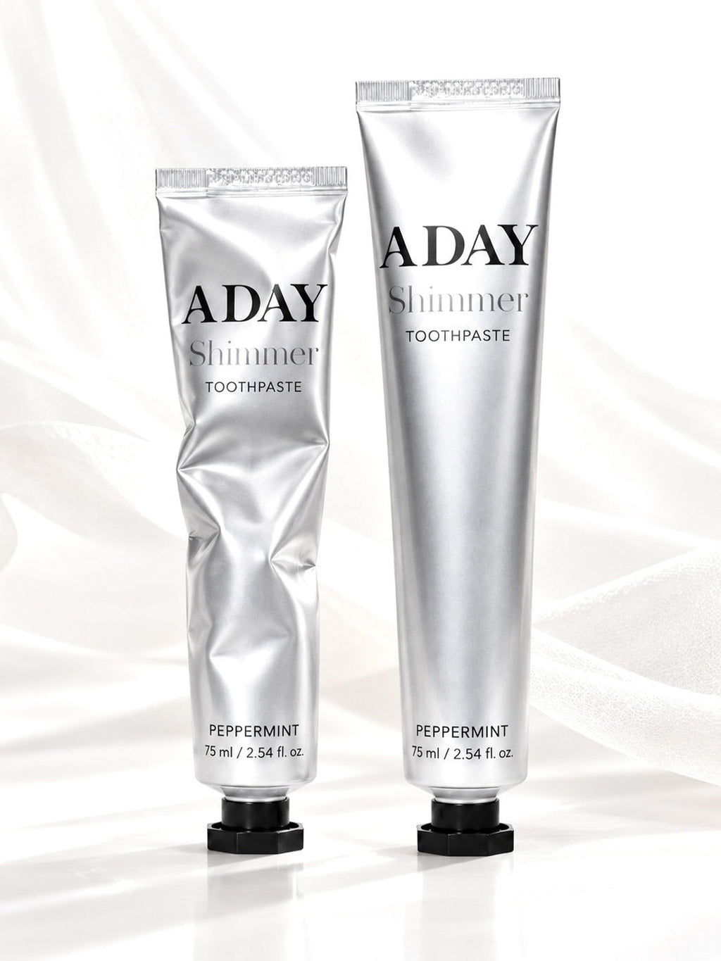 ADAY Shimmer Toothpaste in Silver Peppermint, two 75 ml silver tubes with black octagonal caps