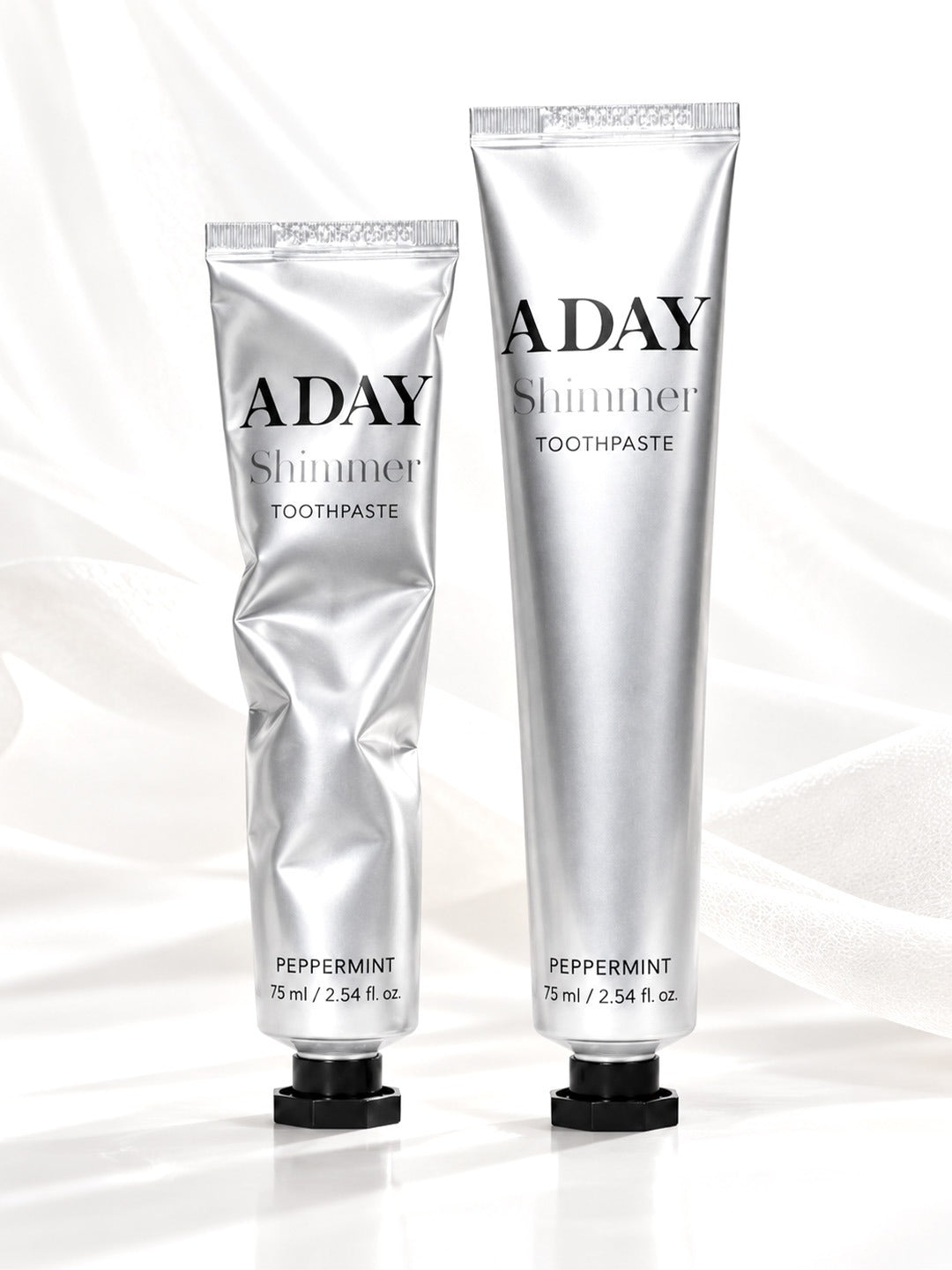 ADAY Shimmer Toothpaste in Silver Peppermint, two 75 ml silver tubes with black octagonal caps