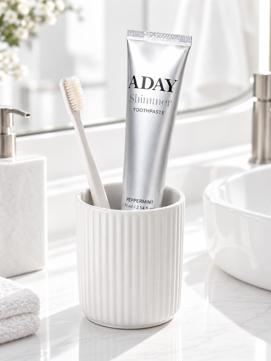 ADAY Silver Shimmer Toothpaste in a ceramic cup with a toothbrush