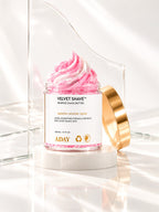 ADAY Velvet Shave Whipped Shave Butter open with its gold lid leaning against the jar