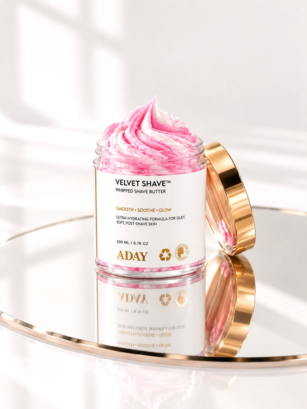 ADAY Velvet Shave Whipped Shave Butter on a gold mirrored tray