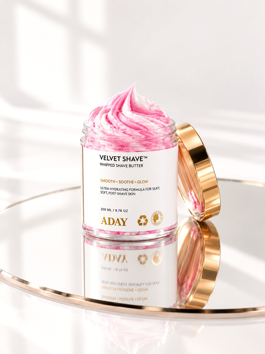 ADAY Velvet Shave Whipped Shave Butter on a gold mirrored tray