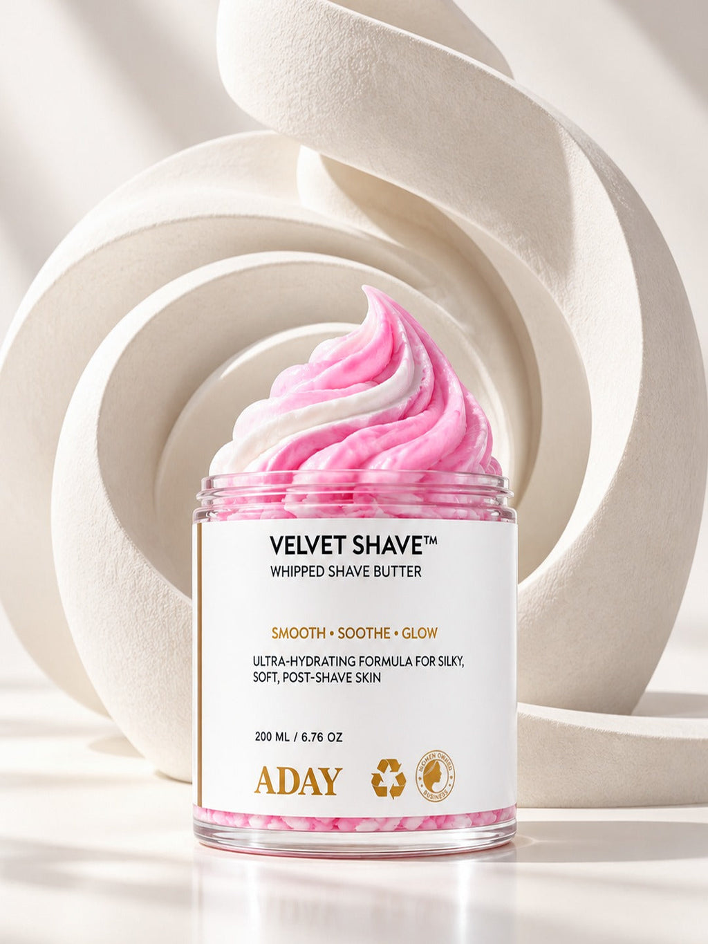 ADAY Velvet Shave Whipped Shave Butter in front of sculptural white arches