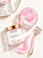 ADAY Velvet Shave Whipped Shave Butter beside a dish of the pink whipped butter, a swirl and a rose-gold razor
