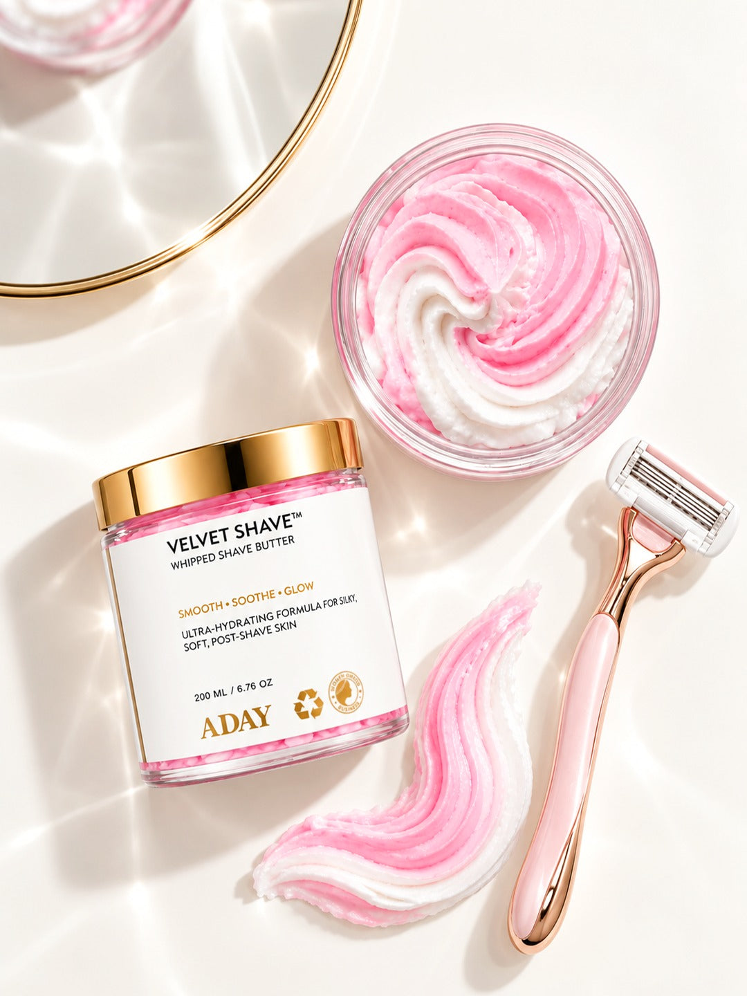 ADAY Velvet Shave Whipped Shave Butter beside a dish of the pink whipped butter, a swirl and a rose-gold razor