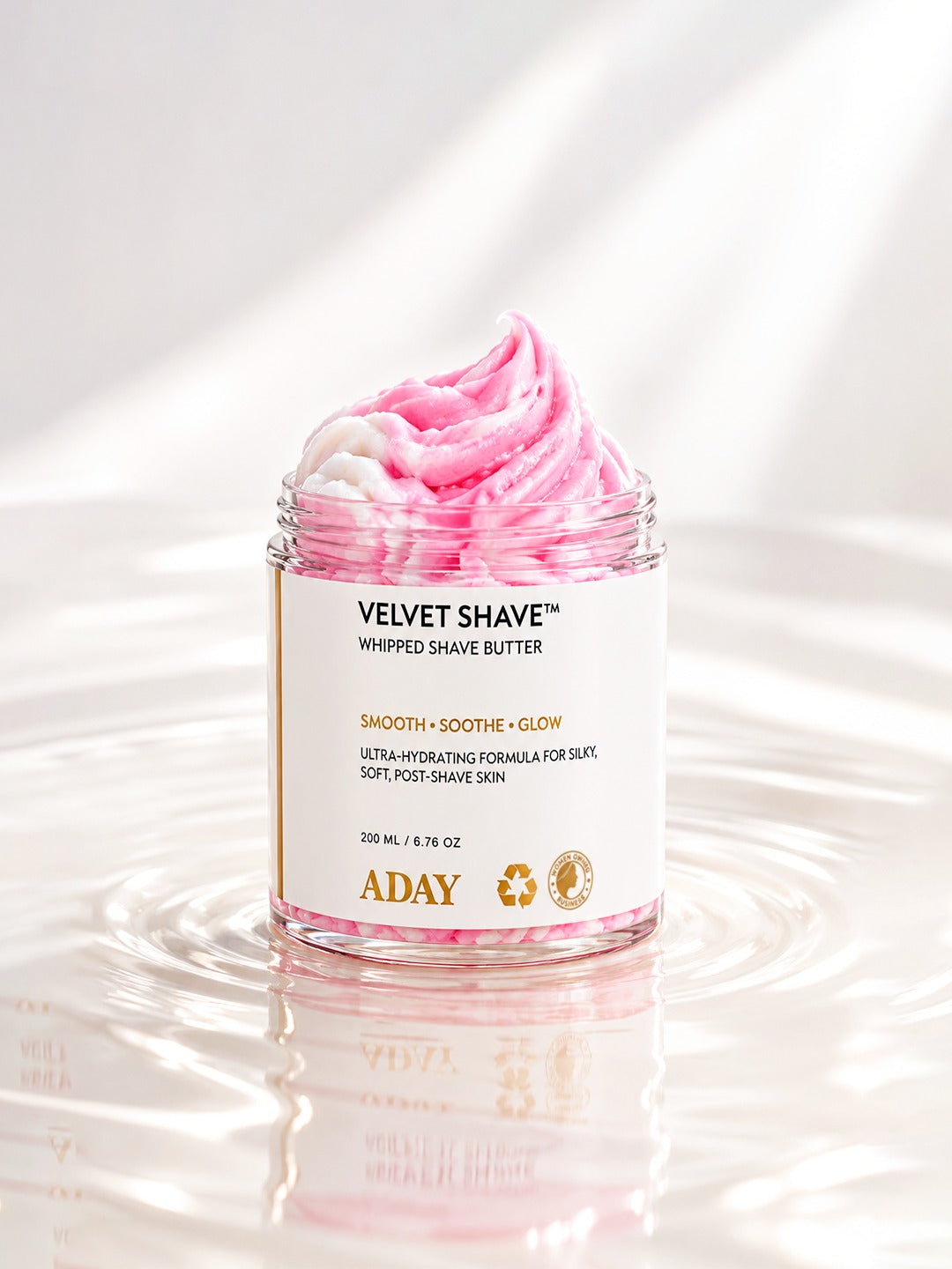 ADAY Velvet Shave Whipped Shave Butter standing in shallow rippling water