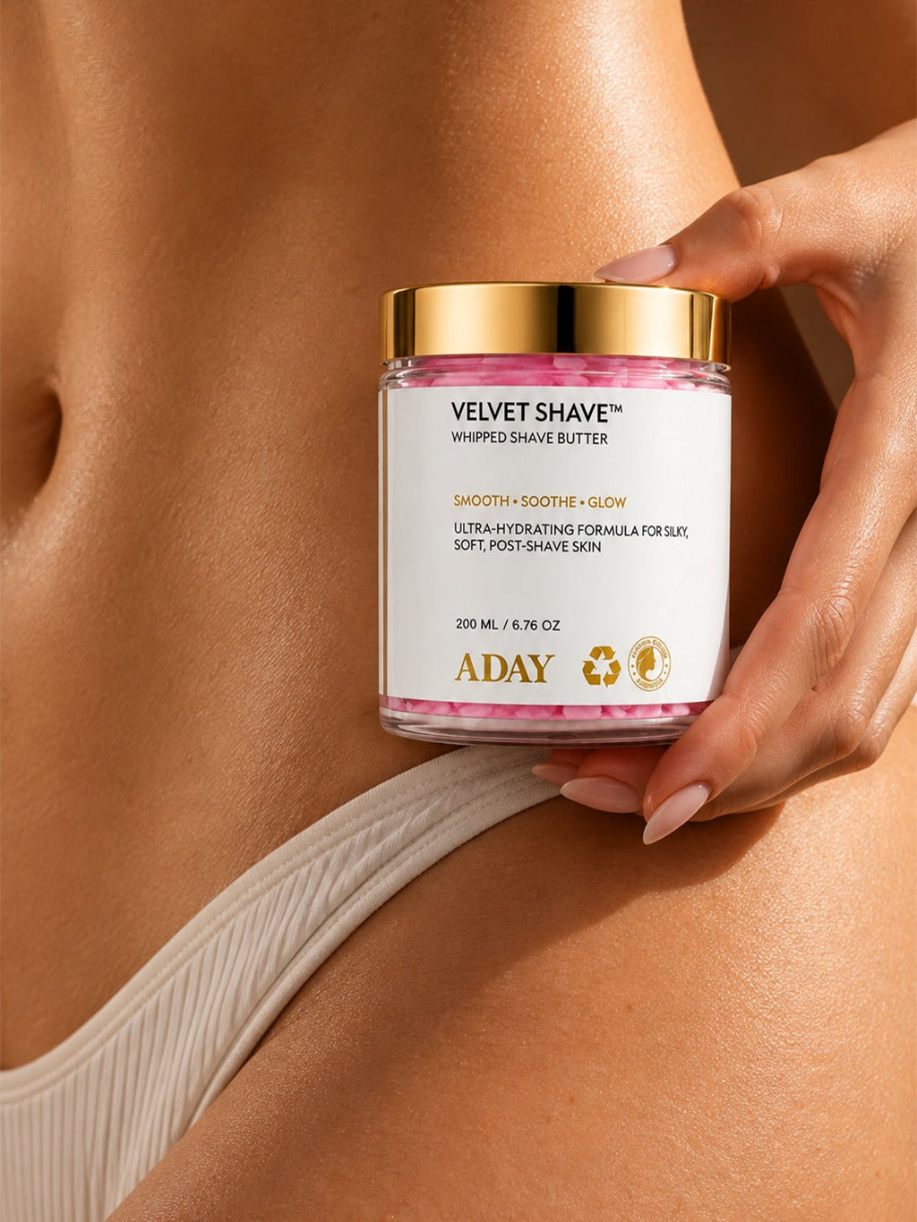 A model holding the ADAY Velvet Shave Whipped Shave Butter at her waist